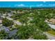 The aerial shot highlights a community neighborhood with well-maintained green spaces and a water tower in the distance at 326 25Th W St, Bradenton, FL 34205