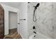 Modern bathroom with a marble-tiled shower, matte black hardware, and wood look flooring at 326 25Th W St, Bradenton, FL 34205