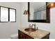 Bathroom featuring a unique copper sink, granite countertop, and rustic bronze lighting fixture at 326 25Th W St, Bradenton, FL 34205