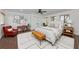 Cozy bedroom with natural lighting, modern furniture, and neutral colors to complement the wood-style tile flooring at 326 25Th W St, Bradenton, FL 34205