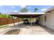 View of the carport with wood roof, concrete floor and driveway at 326 25Th W St, Bradenton, FL 34205