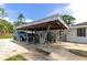 View of a carport featuring weights and truck parking at 326 25Th W St, Bradenton, FL 34205