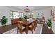 Elegant dining room featuring a large wood table, stylish chandelier, and ample natural light through a large window at 326 25Th W St, Bradenton, FL 34205