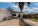 Back exterior view of the house featuring palm trees and stainless grill at 326 25Th W St, Bradenton, FL 34205
