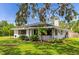 Charming home with brick facade, well-manicured lawn, landscaping and wrought iron details in a lush, mature setting at 326 25Th W St, Bradenton, FL 34205