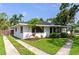 Well-maintained single-story home with fresh landscaping, a driveway, and charming architectural details on a sunny day at 326 25Th W St, Bradenton, FL 34205