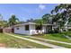 Well-maintained single-story home with fresh landscaping, a driveway, and charming architectural details on a sunny day at 326 25Th W St, Bradenton, FL 34205