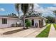Exterior view of a single-story house featuring a grill and palm tree at 326 25Th W St, Bradenton, FL 34205