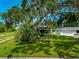 Beautiful front yard featuring a mature tree providing ample shade to the home with a detached garage at 326 25Th W St, Bradenton, FL 34205