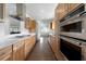 Modern kitchen featuring wood cabinets, stainless steel appliances, and tile flooring that adds a touch of elegance at 326 25Th W St, Bradenton, FL 34205