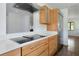 Modern kitchen boasts an induction stovetop, stainless steel appliances, and sleek countertops that compliment the area at 326 25Th W St, Bradenton, FL 34205