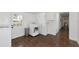 Laundry area featuring a white door, stainless steel trash bin, white cabinets and tile flooring at 326 25Th W St, Bradenton, FL 34205