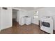 Spacious laundry room with white appliances, storage cabinet, and tile flooring at 326 25Th W St, Bradenton, FL 34205