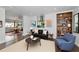 Open living room with modern decor, a black leather sofa, and dining area in the background, perfect for entertaining at 326 25Th W St, Bradenton, FL 34205