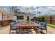 Outdoor dining area with table, seating, and an exterior view of the home at 326 25Th W St, Bradenton, FL 34205