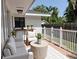 Covered patio with comfortable seating, white fence and decorative plants at 326 25Th W St, Bradenton, FL 34205