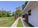 View of a fenced yard and long driveway leading to a covered parking area at 326 25Th W St, Bradenton, FL 34205