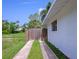 Driveway leading to backyard with wood fence on a sunny day at 326 25Th W St, Bradenton, FL 34205