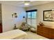Bedroom features a cozy reading nook with cushioned chair and dresser below window at 3407 Avenida Madera # A, Bradenton, FL 34210