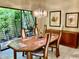 Elegant dining room with a wooden table, chandelier, and scenic outdoor view at 3407 Avenida Madera # A, Bradenton, FL 34210