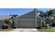 Charming home with an attached garage, well-maintained landscaping, and a lovely palm tree in the front yard at 3407 Avenida Madera # A, Bradenton, FL 34210