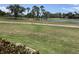 Scenic view of the golf course with lush fairways and a tranquil pond at 3407 Avenida Madera # A, Bradenton, FL 34210