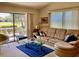 Bright living room with large sliding doors to a patio, plush sofa, and contemporary glass coffee table at 3407 Avenida Madera # A, Bradenton, FL 34210