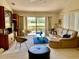 Open living room with neutral carpeting, a large sectional sofa, and sliding glass doors leading to a patio at 3407 Avenida Madera # A, Bradenton, FL 34210