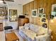 Cozy living room with sofa, wood-paneled walls, and shelving; a printer sits on top of a cabinet at 3407 Avenida Madera # A, Bradenton, FL 34210
