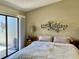 Serene bedroom featuring sliding glass door and stylish decor at 3407 Avenida Madera # A, Bradenton, FL 34210