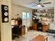 Bright office with two desks, built-in shelves, a ceiling fan, and a bench at 3407 Avenida Madera # A, Bradenton, FL 34210