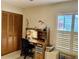 Home office featuring a desk, chair, and shuttered window near a closet at 3407 Avenida Madera # A, Bradenton, FL 34210
