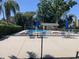 Community pool area with lounge chairs, tables, and a shaded seating area at 3407 Avenida Madera # A, Bradenton, FL 34210