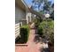 Side walkway with brick pavers, well-manicured hedges and flowering plants at 3407 Avenida Madera # A, Bradenton, FL 34210