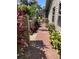 Brick paved walkway with lush landscaping and a view of neighboring homes at 3407 Avenida Madera # A, Bradenton, FL 34210