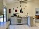 Wet bar featuring modern cabinetry, bar seating, wine fridge, and decorative sailboat wall decor at 3407 Avenida Madera # A, Bradenton, FL 34210