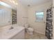 Clean bathroom featuring tiled floors, a vanity with sink, and a shower with a curtain at 3698 N Chamberlain Blvd, North Port, FL 34286