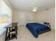 Bright bedroom featuring tiled flooring, natural light, and neutral walls at 3698 N Chamberlain Blvd, North Port, FL 34286