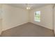 Serene bedroom with a ceiling fan, large window, and plush carpet flooring at 3698 N Chamberlain Blvd, North Port, FL 34286