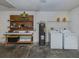 This laundry room has a washer, dryer, and plenty of shelf space for storage and cleaning at 3698 N Chamberlain Blvd, North Port, FL 34286