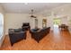 Open living area with tiled floor, ceiling fan, and seamless flow into kitchen and dining at 3698 N Chamberlain Blvd, North Port, FL 34286