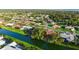 An aerial view shows a waterfront home with an orange roof, surrounded by lush greenery and a canal at 387 Eden Dr Dr, Englewood, FL 34223