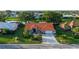 Aerial view of a single-Gathering home with a lush lawn, manicured landscaping, and a spacious driveway at 387 Eden Dr Dr, Englewood, FL 34223