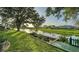 Serene backyard with a tranquil water view, lush landscaping, and a charming wooden walkway at 387 Eden Dr Dr, Englewood, FL 34223