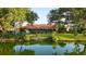 Lush backyard featuring a well-manicured lawn, waterfront views, and a screened-in lanai for outdoor living at 387 Eden Dr Dr, Englewood, FL 34223