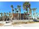 Modern Manasota Beach entrance, framed by palm trees, features clean lines and welcoming pathway at 387 Eden Dr Dr, Englewood, FL 34223