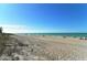 Expansive beach view with soft sand, calm waves, and a clear blue sky perfect for relaxation at 387 Eden Dr Dr, Englewood, FL 34223
