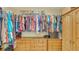Walk-in closet with custom wooden drawers, shelving, and ample hanging space at 387 Eden Dr Dr, Englewood, FL 34223