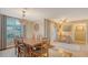 Stylish dining room with wood table, decorative chandelier, and lots of natural light at 387 Eden Dr Dr, Englewood, FL 34223