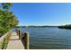 Community dock with wooden posts, with calm water views in a serene natural environment, perfect waterfront access at 387 Eden Dr Dr, Englewood, FL 34223